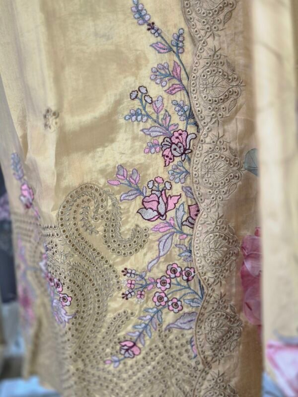 Premium mustard organza embroidered suit set with floral printed dupatta and shantoon bottom displayed in luxury studio setup