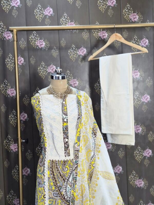 Yellow cotton salwar suit with printed kurta, cotton bottom and cotton dupatta displayed on mannequin in premium studio setup