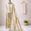Yellow cotton salwar suit with printed kurta, cotton bottom and cotton dupatta displayed on mannequin in premium studio setup